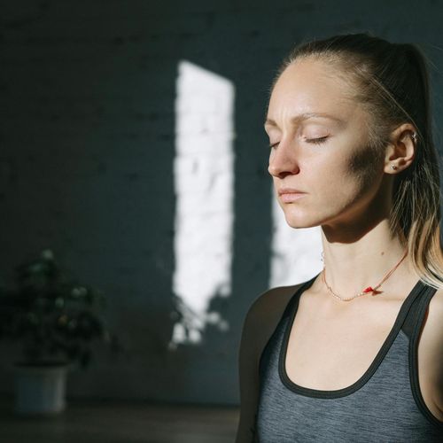 Close-up of a person with eyes closed, in deep concentration during yoga.