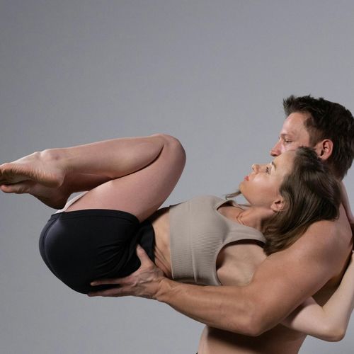 Person holding a challenging yoga pose demonstrating strength.